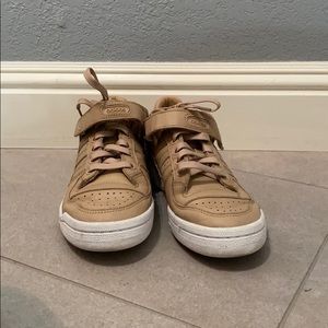 Tan and white Adidas sneakers